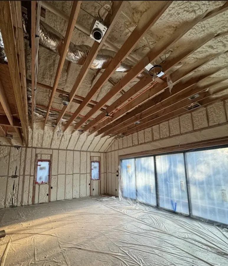 Interior walls and ceiling insulated with spray foam during new construction in El Granada
